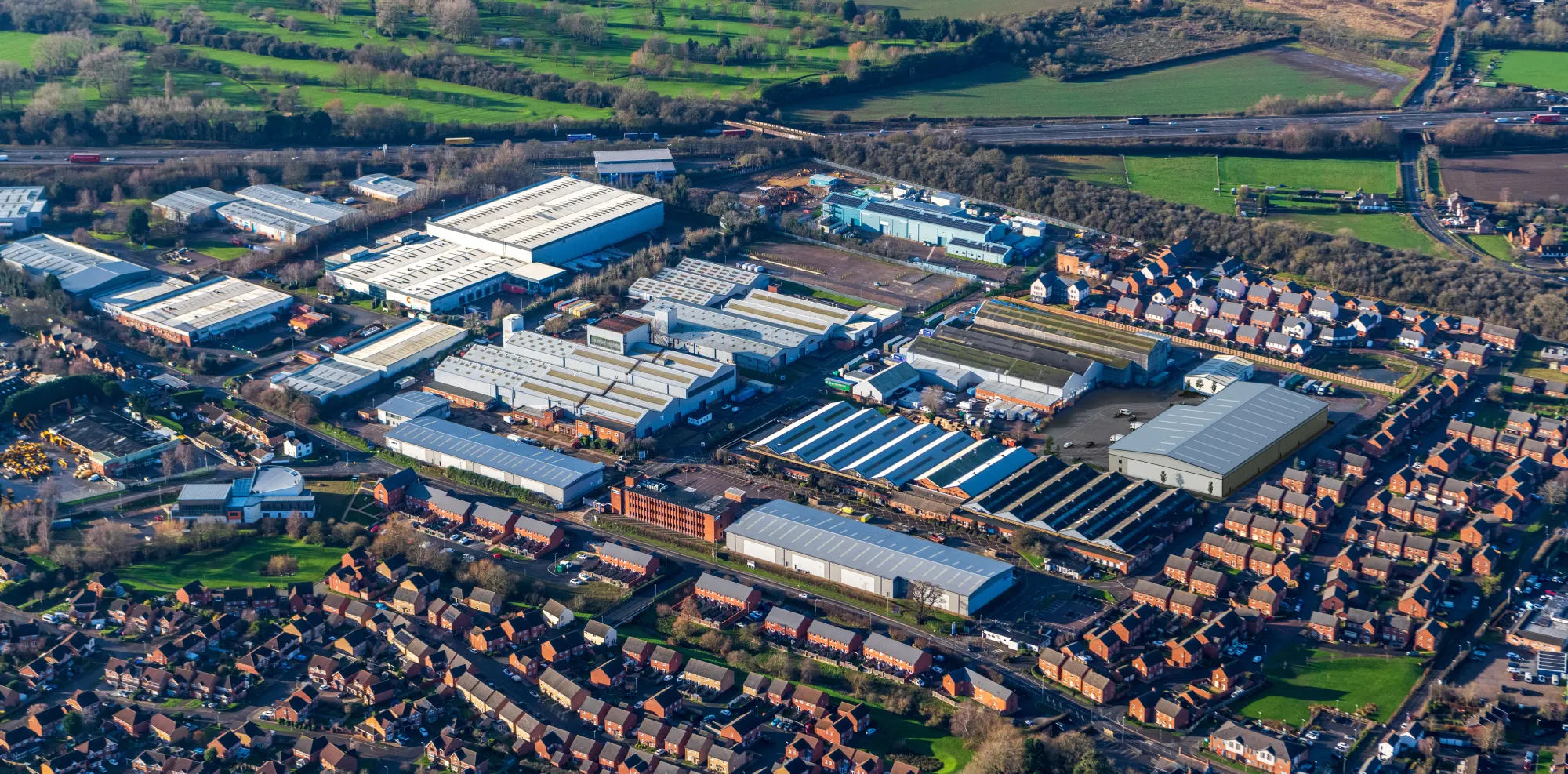 Aerial photograph of Whittle Estate, Whetstone, with the M1 behind