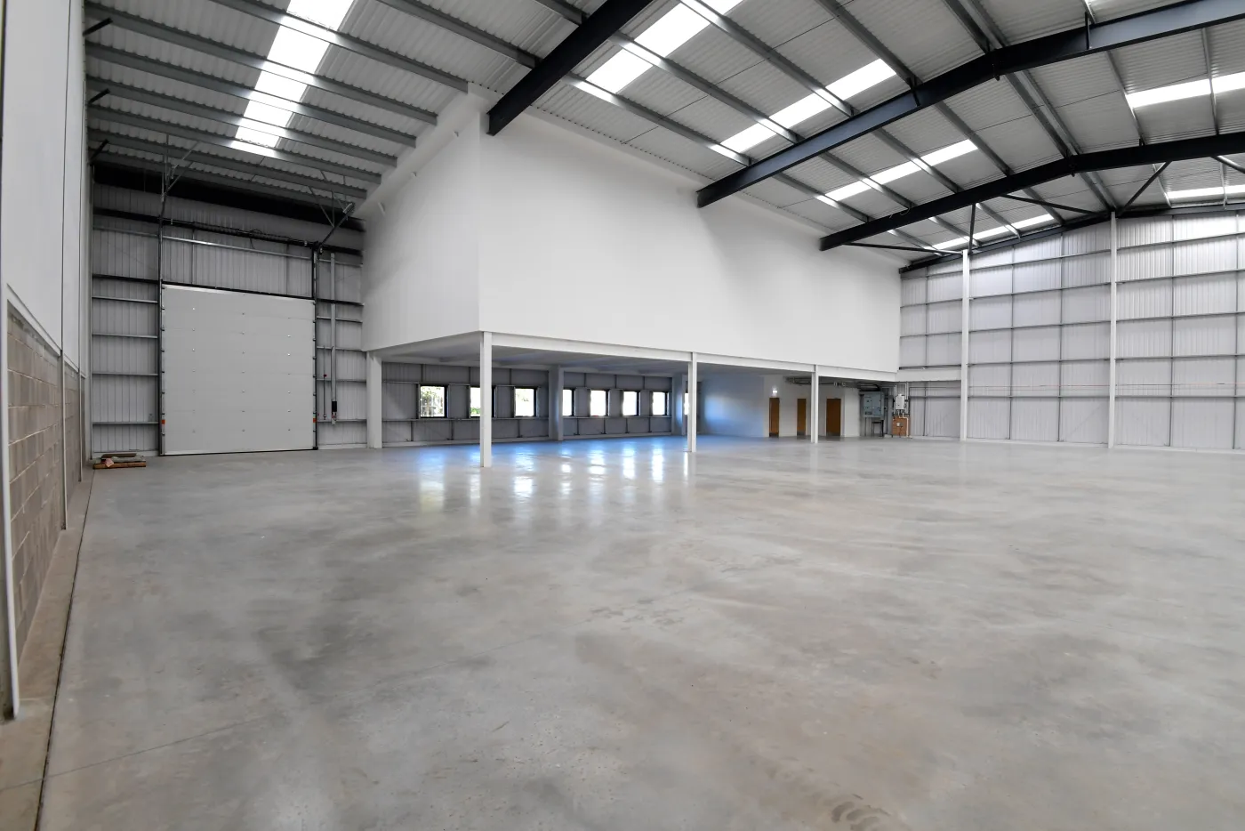 Indicative warehouse interior with a level access door and first floor offices